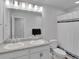 Bathroom with double sinks, granite countertop, and a bathtub with shower at 18938 E 64Th Pl, Denver, CO 80249