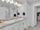 Bathroom featuring double sinks, a granite countertop, and a glass-enclosed shower at 18938 E 64Th Pl, Denver, CO 80249