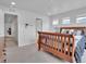 Bright bedroom with a wooden sleigh bed, neutral walls, and sun-filled windows at 18938 E 64Th Pl, Denver, CO 80249