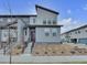 Modern two-story home with gray siding, stylish landscaping, and a welcoming front entrance at 18938 E 64Th Pl, Denver, CO 80249