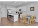 Bright kitchen with stainless steel appliances, granite countertops, and an island with bar seating at 18938 E 64Th Pl, Denver, CO 80249