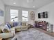 Bright living room with a comfortable sofa, entertainment center, and modern decor at 18938 E 64Th Pl, Denver, CO 80249