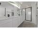 Modern bathroom features a double vanity, black fixtures, and a glass enclosed shower with tile surround at 20520 E 58Th Ave, Aurora, CO 80019
