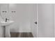 Modern bathroom with a pedestal sink and sleek fixtures at 20520 E 58Th Ave, Aurora, CO 80019