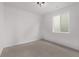 Bedroom features a light fixture, window, neutral carpet, and fresh paint at 20520 E 58Th Ave, Aurora, CO 80019