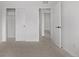Cozy bedroom with neutral carpet, fresh paint and a door to the ensuite bathroom and closet at 20520 E 58Th Ave, Aurora, CO 80019