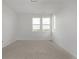 Spacious bedroom is filled with natural light from the large windows, highlighting the neutral carpet at 20520 E 58Th Ave, Aurora, CO 80019