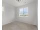 Bright bedroom features a large window with a view, neutral carpet, and fresh paint at 20520 E 58Th Ave, Aurora, CO 80019
