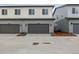 Modern townhome exterior with gray siding and a spacious two-car garage at 20520 E 58Th Ave, Aurora, CO 80019