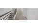 Carpeted hallway features modern railing and leads to other rooms in the home at 20520 E 58Th Ave, Aurora, CO 80019