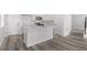 Stylish kitchen features modern white cabinets and a central island at 20520 E 58Th Ave, Aurora, CO 80019