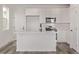 Modern kitchen featuring sleek white cabinetry and an island with a sink at 20520 E 58Th Ave, Aurora, CO 80019