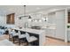 Bright kitchen features a large island with seating, modern lighting and cabinetry at 2349 S Bannock St, Denver, CO 80223