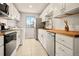 Bright kitchen featuring white cabinets, wood countertops, stainless steel appliances, and a window view at 7946 Chase Cir # 112, Arvada, CO 80003