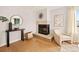 Cozy living room featuring a fireplace and light wood floors at 7946 Chase Cir # 112, Arvada, CO 80003