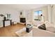 Bright living room with hardwood floors, fireplace, and plenty of natural light from the large window at 7946 Chase Cir # 112, Arvada, CO 80003
