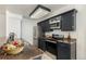 Galley kitchen with dark cabinets and granite countertops at 2072 S Helena St # D, Aurora, CO 80013