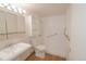 Bathroom featuring walk in shower, grab bars, neutral walls, tile flooring and recessed lighting at 799 Dahlia St # 201, Denver, CO 80220