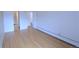 Bedroom featuring wood floors and access to a hall at 799 Dahlia St # 201, Denver, CO 80220