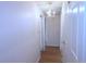 Hallway with white walls, chandelier-style light fixture, wood floors, and doors at 799 Dahlia St # 201, Denver, CO 80220