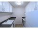 Galley kitchen featuring all-white appliances, cabinets and countertops, with tile flooring at 799 Dahlia St # 201, Denver, CO 80220