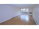Living room features neutral walls, wood floors, and a sliding glass door to a balcony at 799 Dahlia St # 201, Denver, CO 80220
