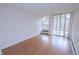 Bright living room featuring wood floors and sliding glass doors with access to a private balcony at 799 Dahlia St # 201, Denver, CO 80220