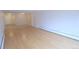 Living room features neutral walls, wood and tile floors, a door and entrance to kitchen at 799 Dahlia St # 201, Denver, CO 80220