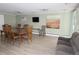 Bright living room with tile floors, modern decor, a large dining table, and a comfortable sofa at 799 Dahlia St # 201, Denver, CO 80220