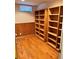 This basement has hardwood floors and built-in bookshelves with natural lighting, perfect for storage or a home office at 2124 S Yates St, Denver, CO 80219