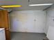 This basement storage unit features a wall of white storage units that match the neutral walls and ceiling at 2124 S Yates St, Denver, CO 80219