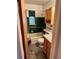 Bathroom with a shower and tub combo, green tile and vintage fixtures at 2124 S Yates St, Denver, CO 80219