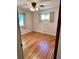 Cozy bedroom with hardwood floors and natural light from two windows at 2124 S Yates St, Denver, CO 80219