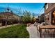 Landscaped backyard featuring a seating area, dining table, and lush lawn at 2794 Lima St, Denver, CO 80238