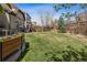 Spacious backyard with a vibrant lawn, fence, and a play area in a Gathering-friendly setting at 2794 Lima St, Denver, CO 80238