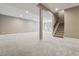 Spacious finished basement featuring neutral walls, carpet flooring, and staircase access at 2794 Lima St, Denver, CO 80238