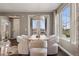 Elegant dining area featuring stylish chairs, a modern chandelier, and natural light from large windows at 2794 Lima St, Denver, CO 80238