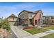Attractive two-story home with a brick and siding exterior, well-manicured lawn, and a detached garage at 2794 Lima St, Denver, CO 80238
