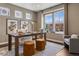 Bright home office featuring a large window, modern lighting, desk, neutral color palette, and a comfortable seating area at 2794 Lima St, Denver, CO 80238