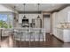 Bright, modern kitchen with white cabinets, stainless steel appliances, granite countertops, and pendant lighting at 2794 Lima St, Denver, CO 80238