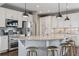 Bright, modern kitchen featuring white cabinets, stainless steel appliances, and a granite countertop island with seating at 2794 Lima St, Denver, CO 80238