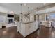 Open-concept kitchen, seamlessly connected to a cozy living space with fireplace and staircase at 2794 Lima St, Denver, CO 80238
