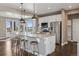 Open kitchen layout featuring a large island, stainless steel appliances, and a view to the backyard at 2794 Lima St, Denver, CO 80238