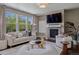 Bright living room with large windows, a cozy fireplace, and comfortable seating, perfect for relaxation at 2794 Lima St, Denver, CO 80238