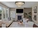 Cozy living room with modern decor, featuring a fireplace, comfortable seating, and ample natural light at 2794 Lima St, Denver, CO 80238