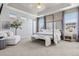 Airy main bedroom with a four-poster bed, accent wall, sitting area, and great light at 2794 Lima St, Denver, CO 80238
