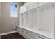 Mud room with white storage, drawer space, hooks, and a window for natural lighting at 2794 Lima St, Denver, CO 80238
