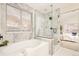 Spa-like bathroom with large shower, soaking tub and marble tile at 6716 W 97Th Cir, Broomfield, CO 80021