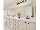 Updated bathroom with double vanity, modern fixtures, and mirrors at 6716 W 97Th Cir, Broomfield, CO 80021