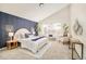 Spacious main bedroom with navy accent wall and large window at 6716 W 97Th Cir, Broomfield, CO 80021